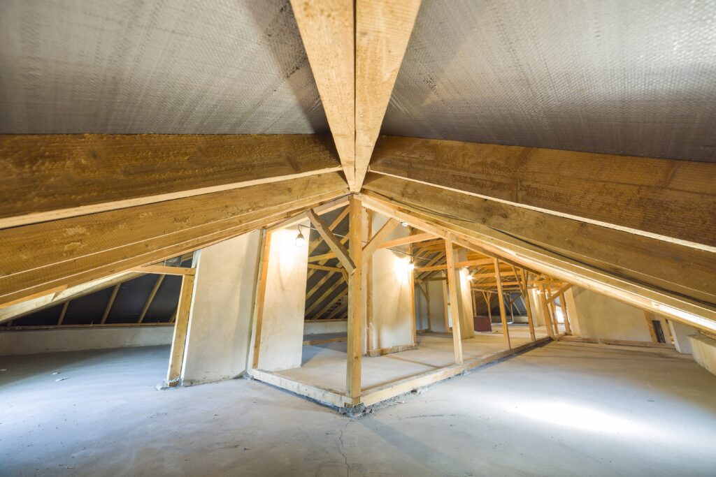 Attic of a building with wooden beams of a roof structure.
